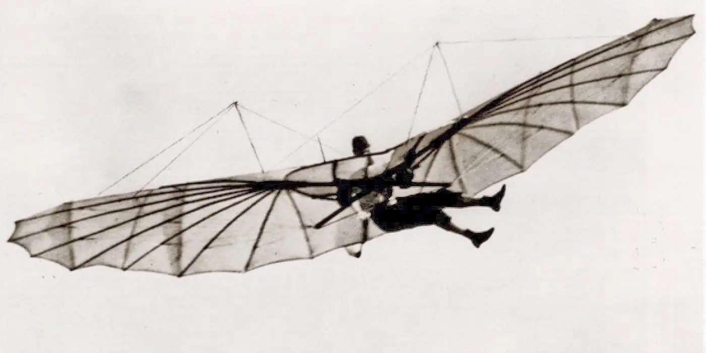 Otto Lilienthal hanging beneath his bat-winged glider in mid-air.